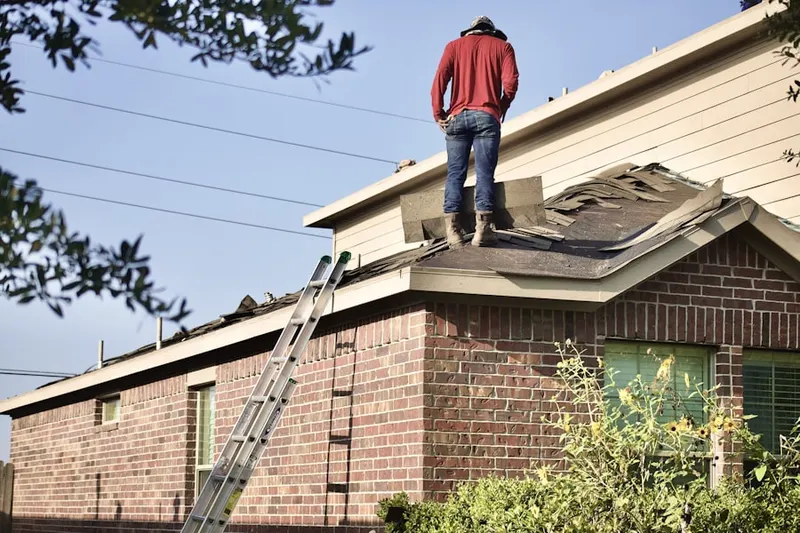 Professional roofer working on a residential roof in Westhaven
